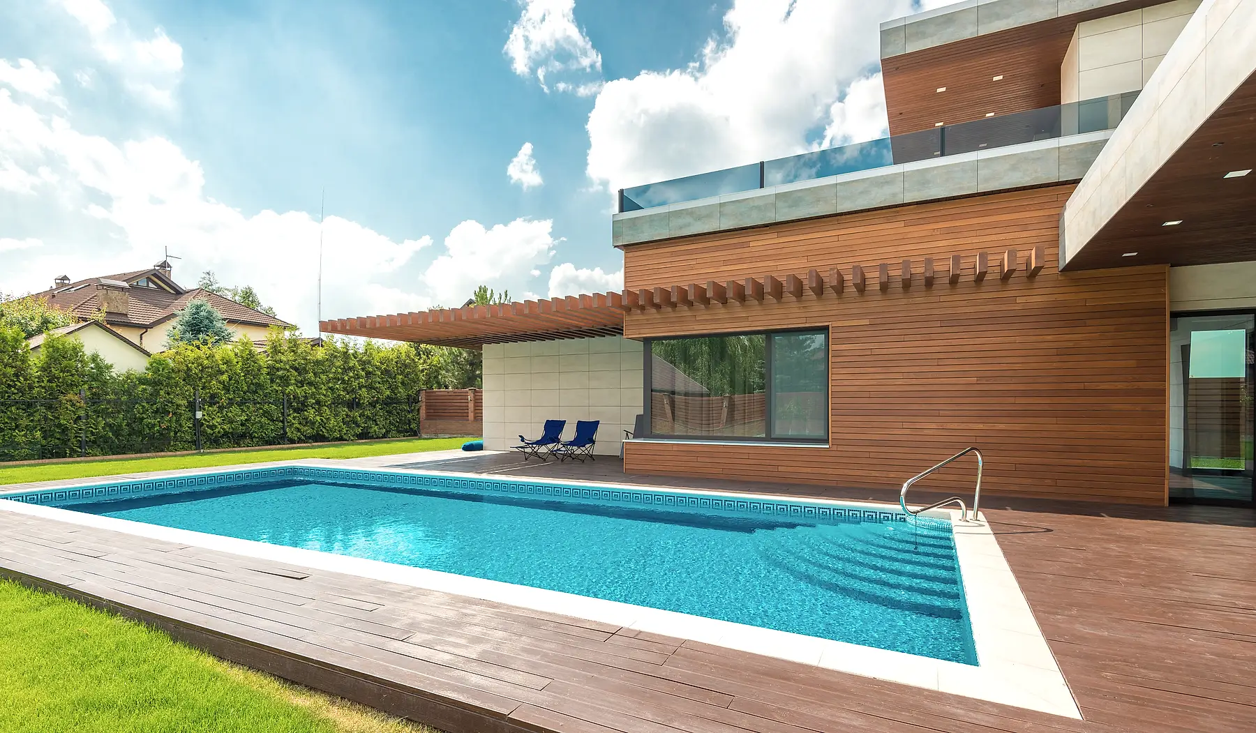 Modern pool terrace with ipe deck and cedar pergola