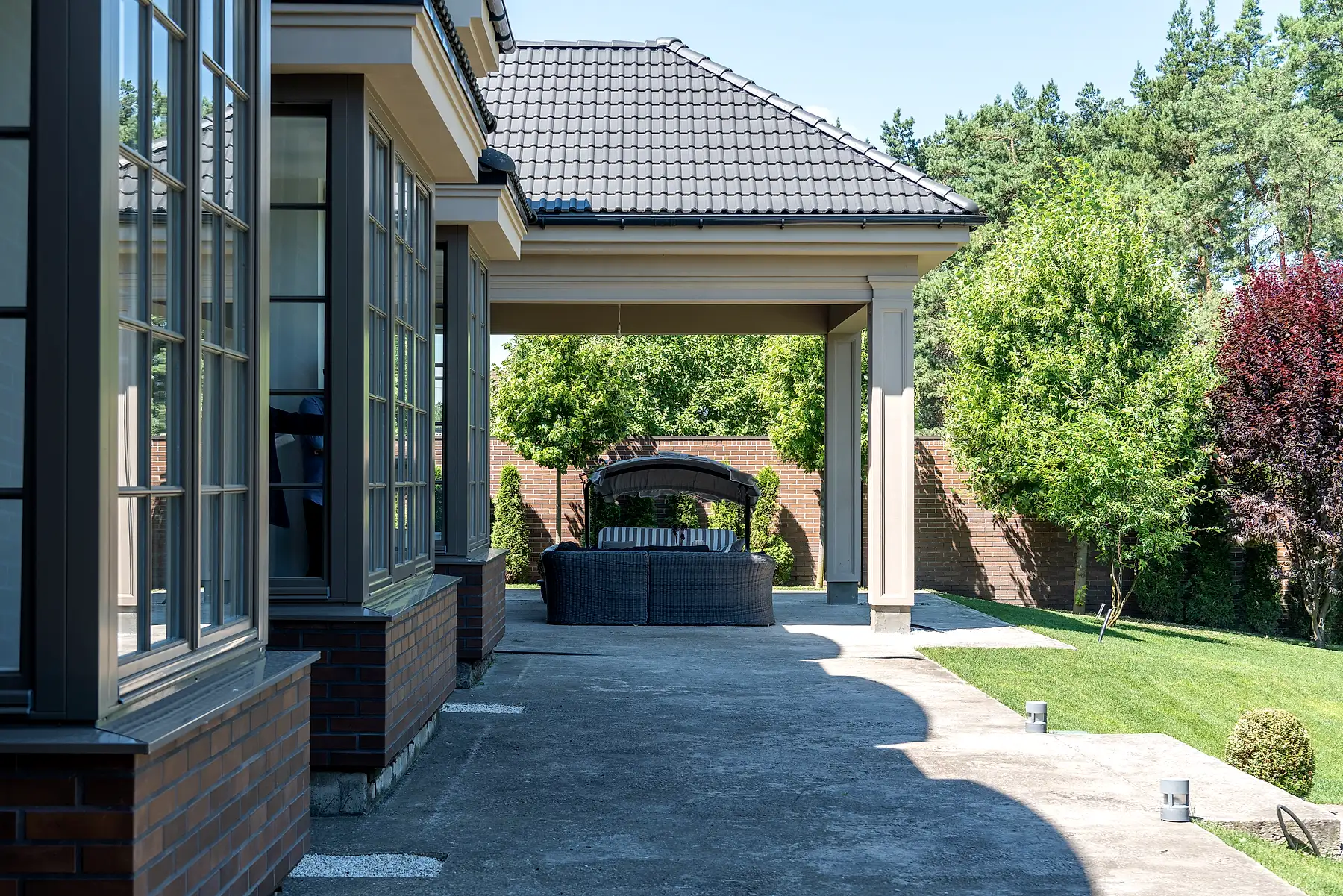 Covered stone terrace with garden lounge